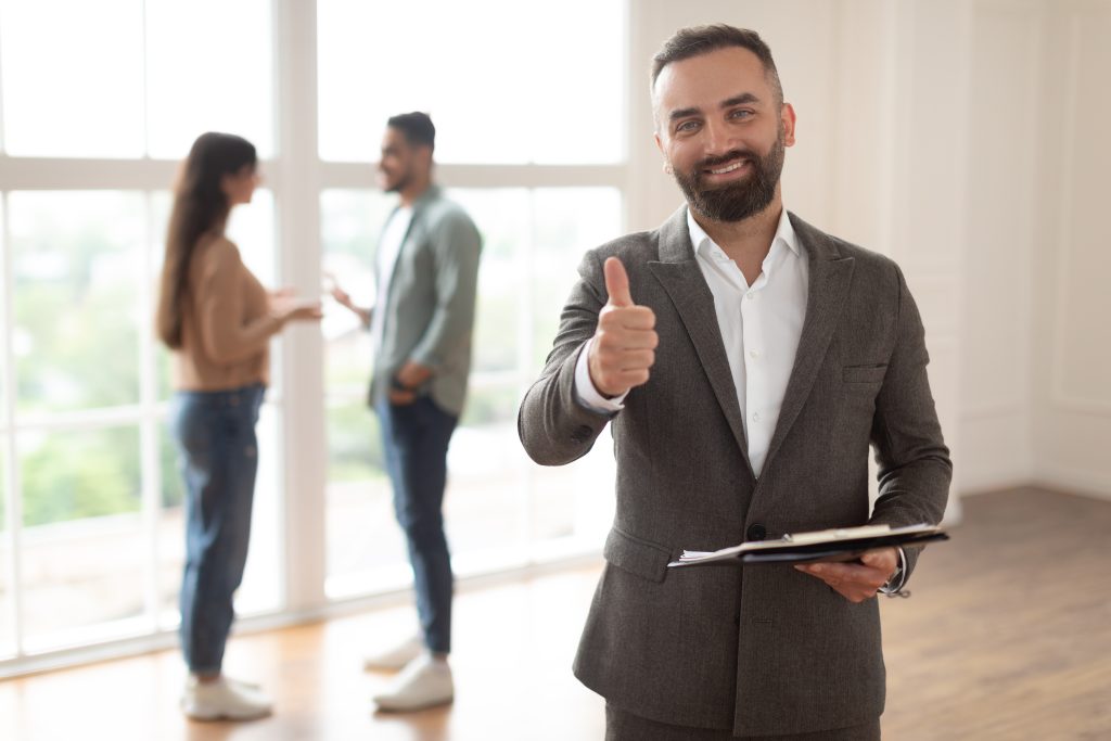 Portrait Of Real Estate Agent Showing Thumbs Up Like Sign